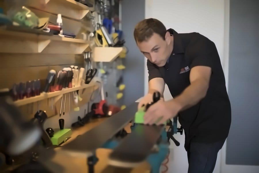 Sam planing a ski base at the workbench