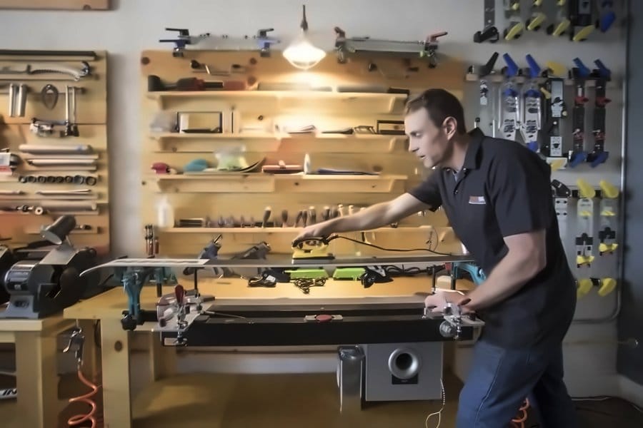 Hand-ironing hot wax into a ski base