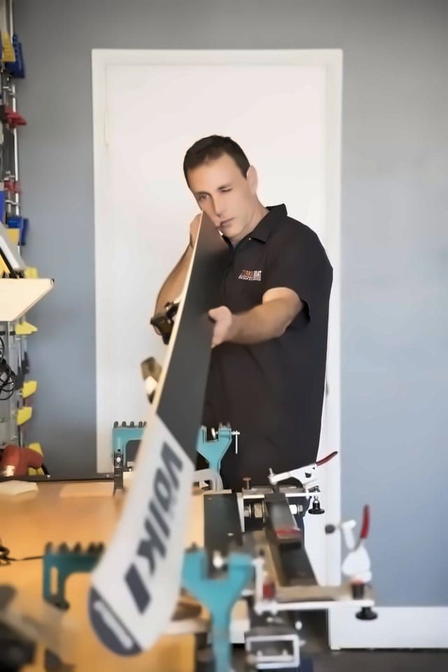 Sam sighting down a Volkl ski base to check that it runs flat
