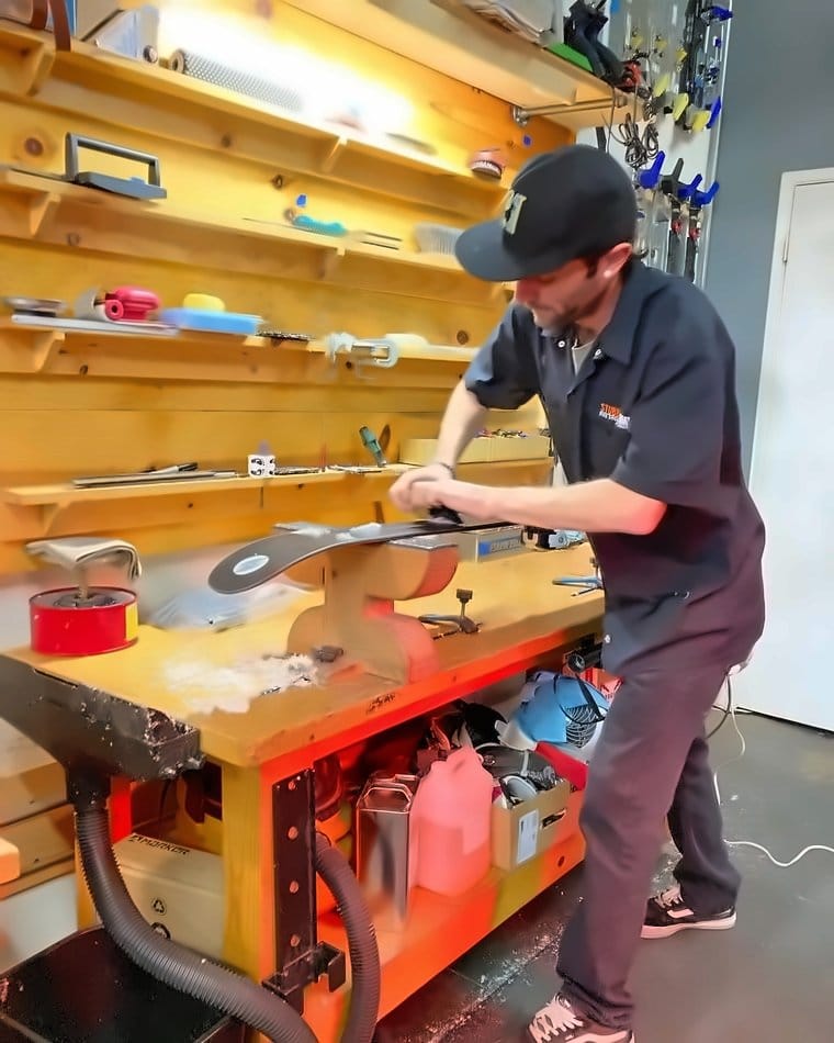 Hand-finishing a ski at the workbench