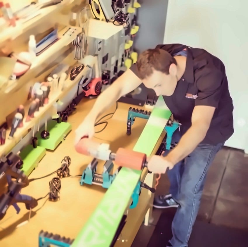 Technician buffing a ski base at the bench