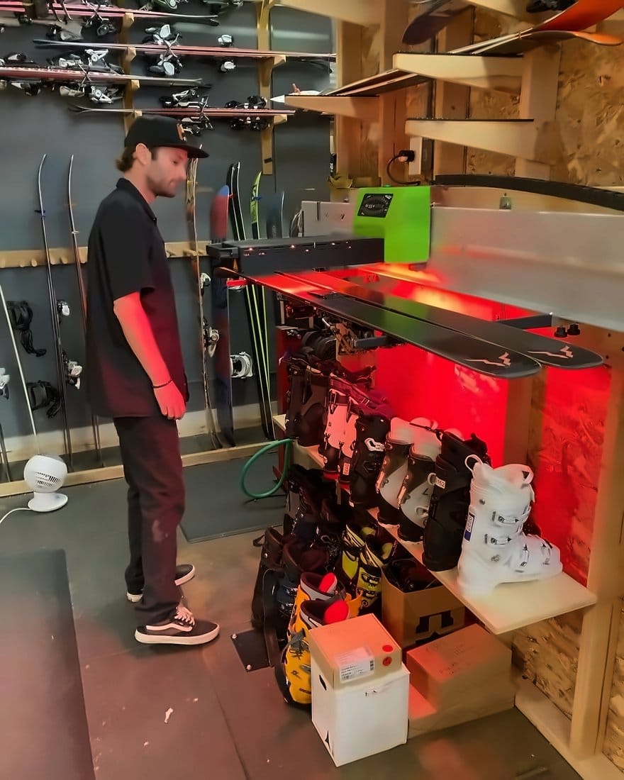 Technician loading skis into the automated Wax Future machine