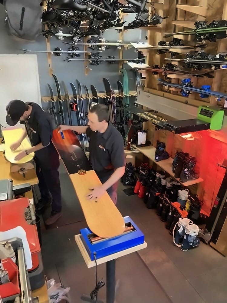 Loading a snowboard into the automated wax machine