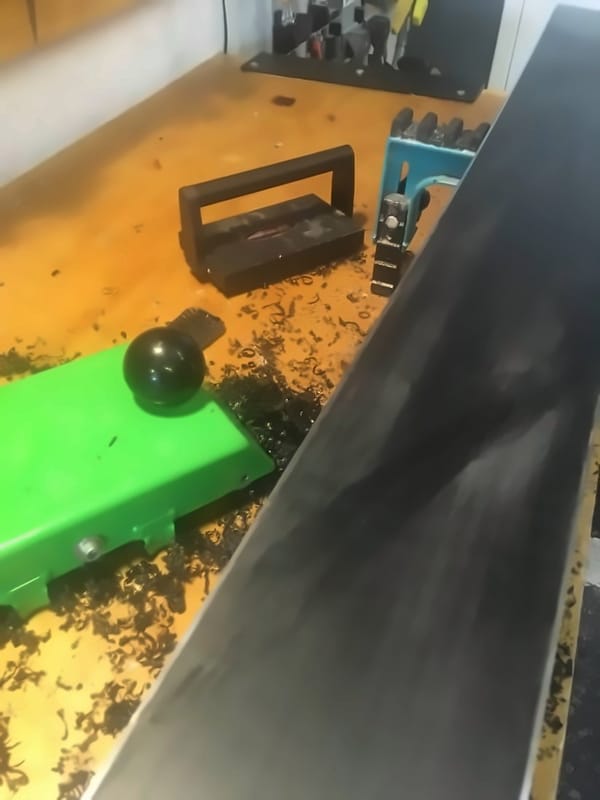 Excess P-tex scraped off a ski base, with shavings on the workbench